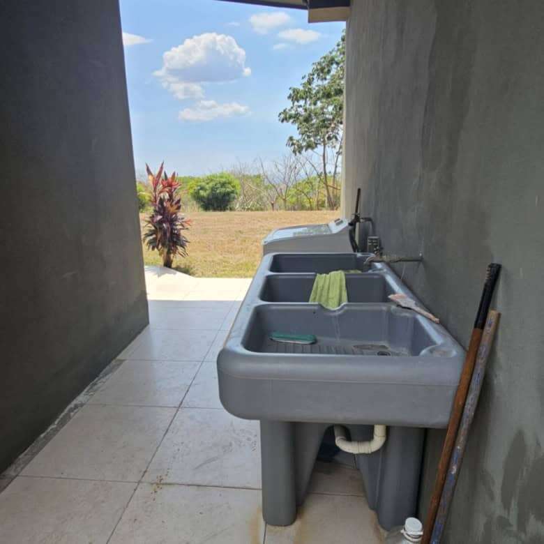 Laundry space with outdoor view and greenery in Costa Rica villa.