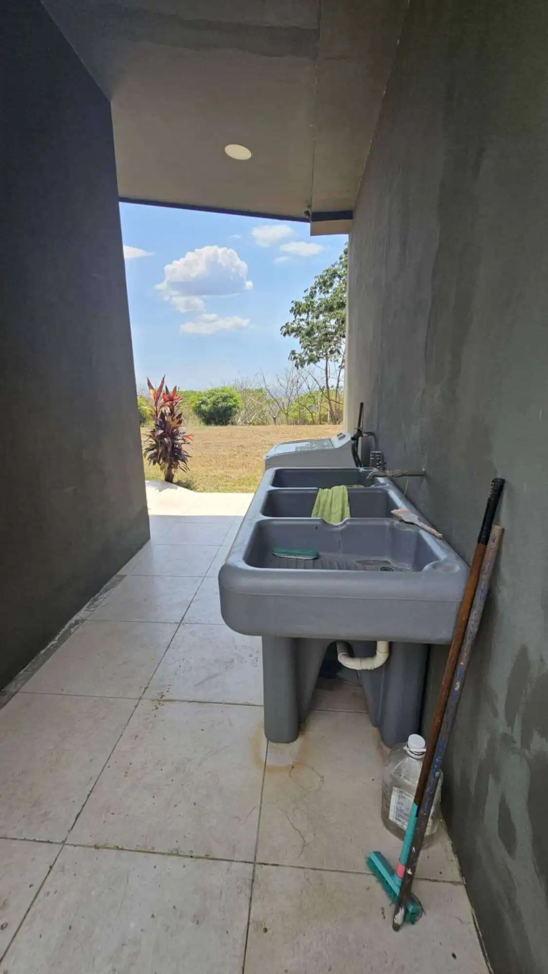 Laundry space with outdoor view and greenery in Costa Rica villa.