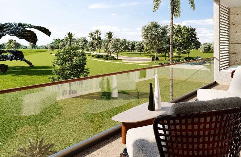 Balcony overlooking lush green golf course and tropical landscape in Punta Cana.