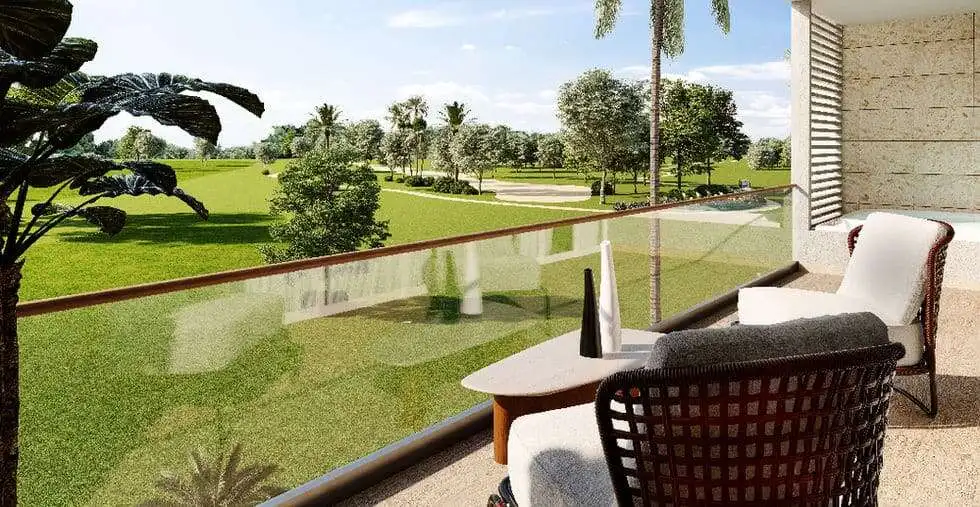 Balcony overlooking lush green golf course and tropical landscape in Punta Cana.