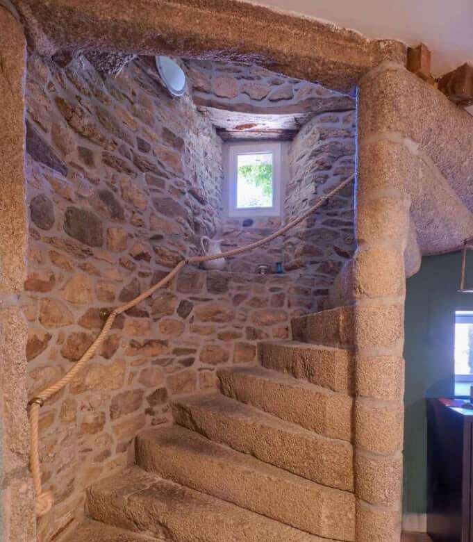 Stone staircase inside a historic gite complex in Brittany.