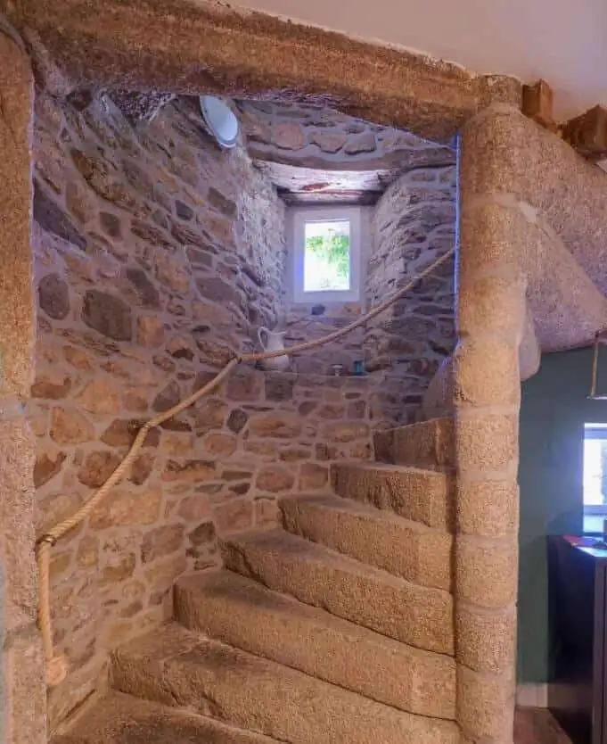 Stone staircase inside a historic gite complex in Brittany.