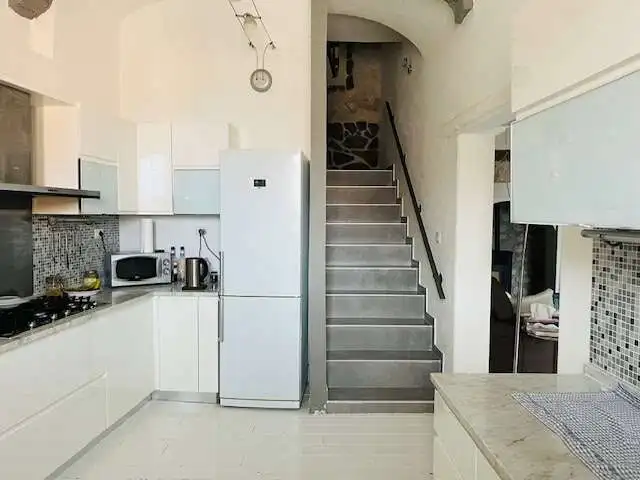 Chiaramonti Sardinia 3-Bed House with modern kitchen and staircase.