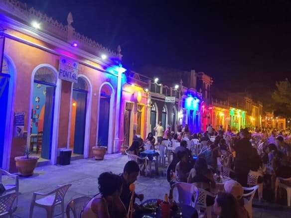 Brightly lit colonial houses in Bahia at night.