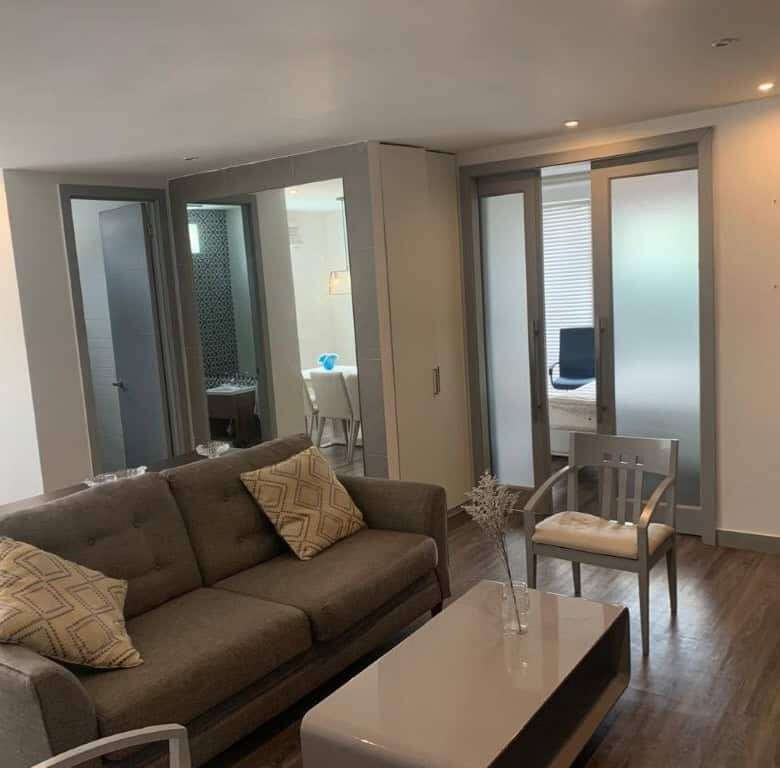 Modern living room with stylish furniture and large glass doors in Panama City.