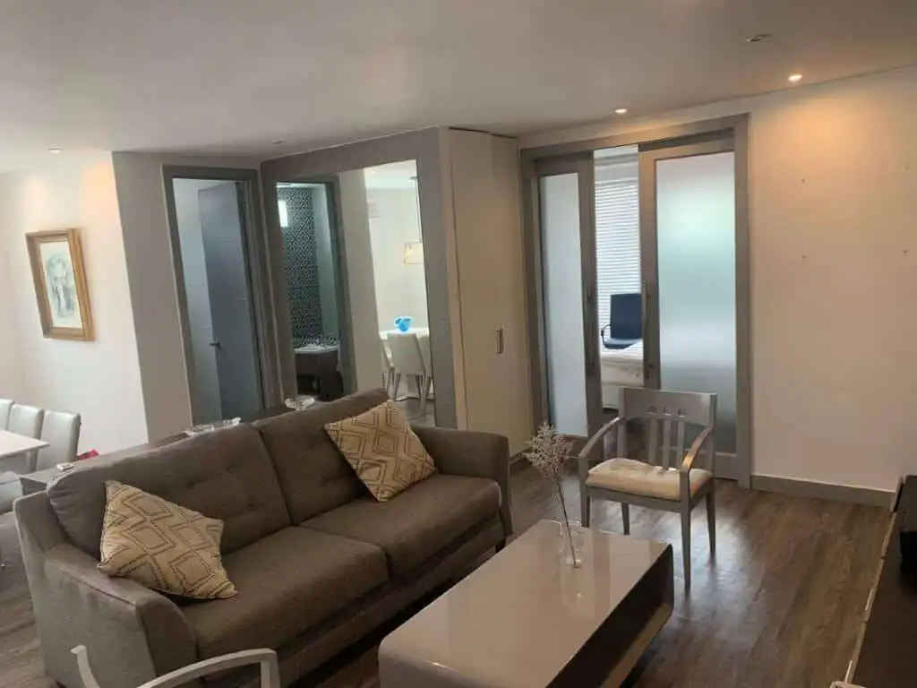 Modern living room with stylish furniture and large glass doors in Panama City.