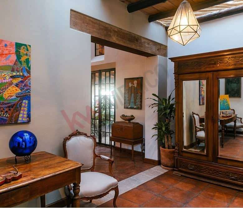 Style living room with antique furniture and vibrant artwork.