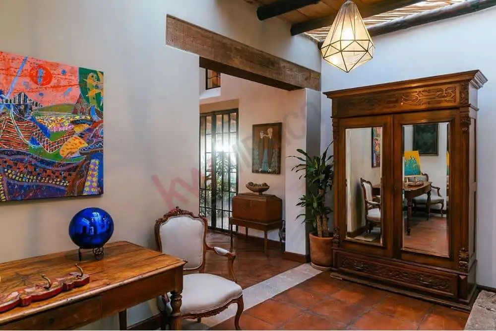 Exquisite Colonial Estate Interior Style living room with antique furniture and vibrant artwork.