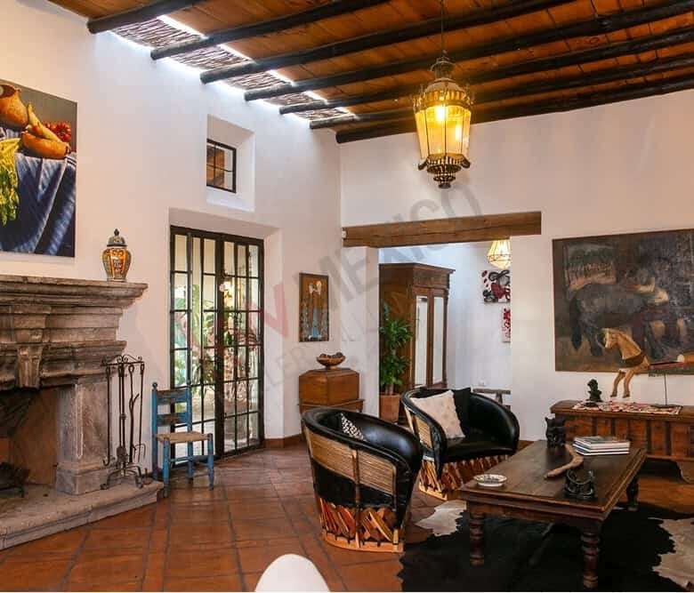 Style living room featuring wooden beams, vintage furniture, and vibrant artwork.