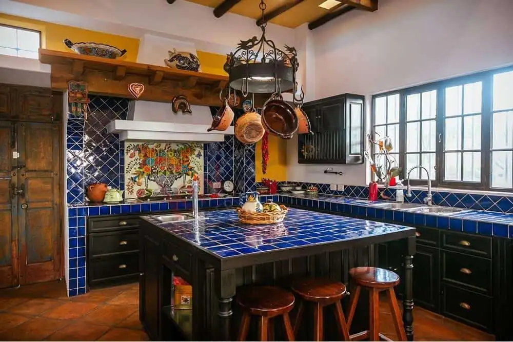 Charming Colonial Kitchen with Traditional Decor Style kitchen featuring vibrant blue tiles and rustic wooden accents.