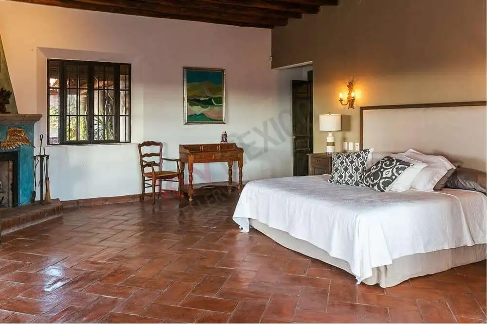 Elegant Colonial Bedroom with Dam Views Spacious bedroom in colonial estate with dam views and rustic decor.