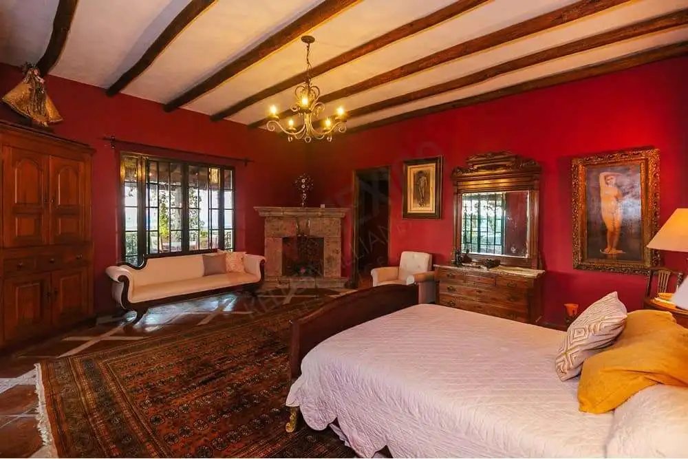 Elegant Colonial Bedroom with Allende Dam Views Elegant colonial bedroom with vintage decor and large windows overlooking Allende Dam.