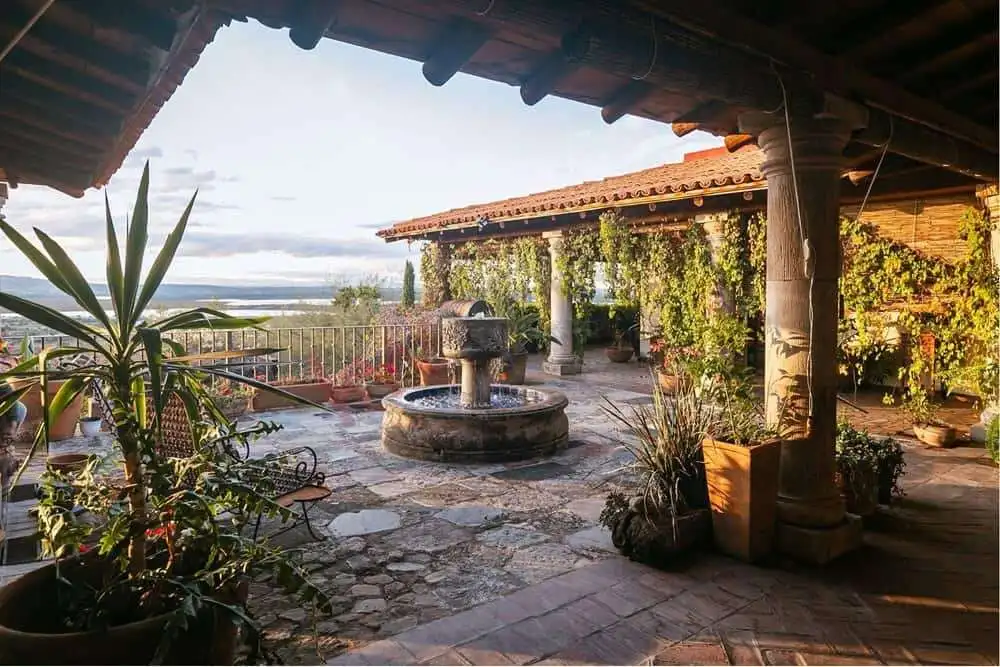 Elegant colonial estate terrace with dam views and lush greenery. Colonial estate terrace with dam views and lush greenery.