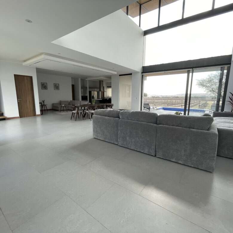 Spacious modern living room with large windows and natural light in San Miguel de Allende.