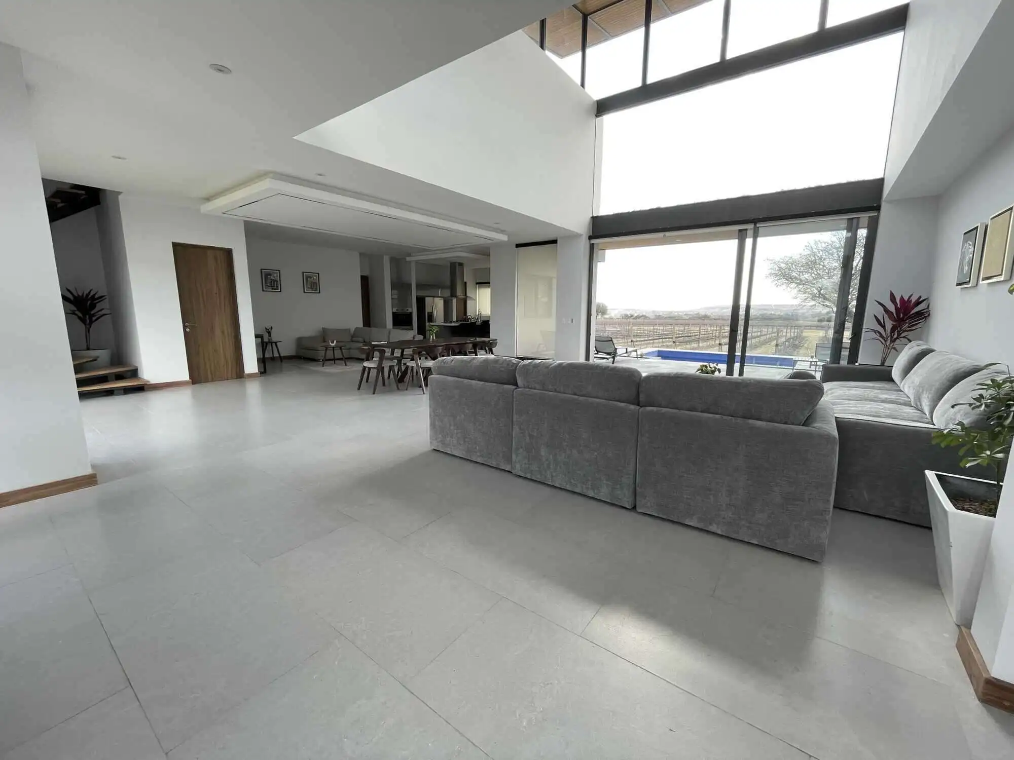 Spacious modern living room with large windows and natural light in San Miguel de Allende.