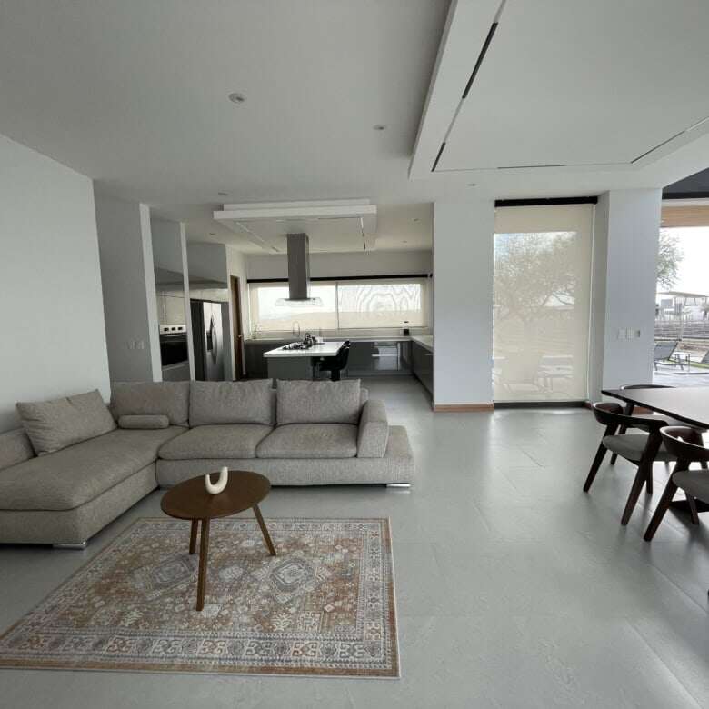 Elegant modern interior with spacious living area and large windows.