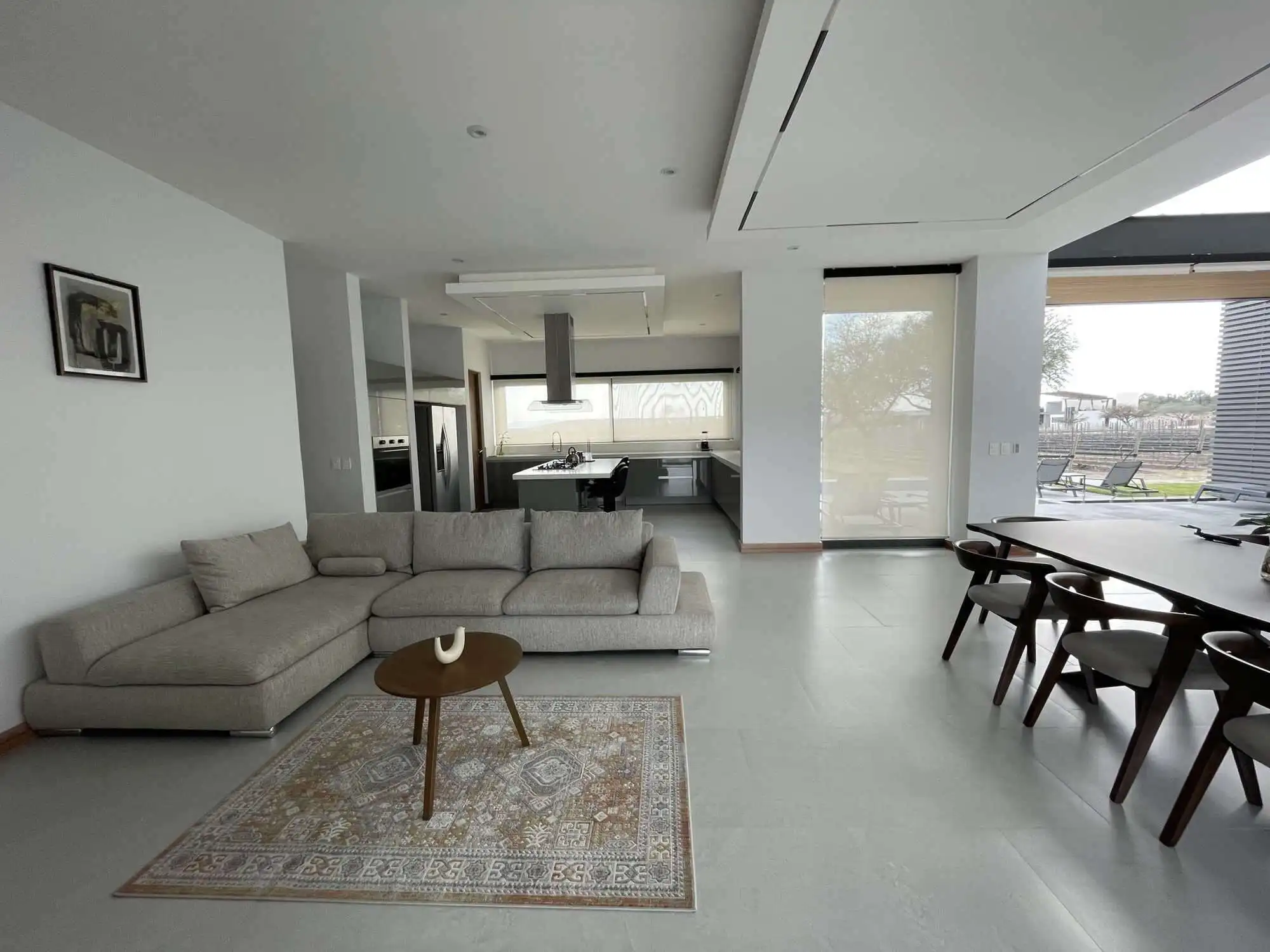 Elegant modern interior with spacious living area and large windows.