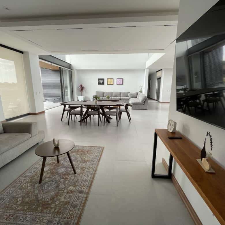 Spacious modern living room with elegant furniture and large windows in San Miguel de Allende.