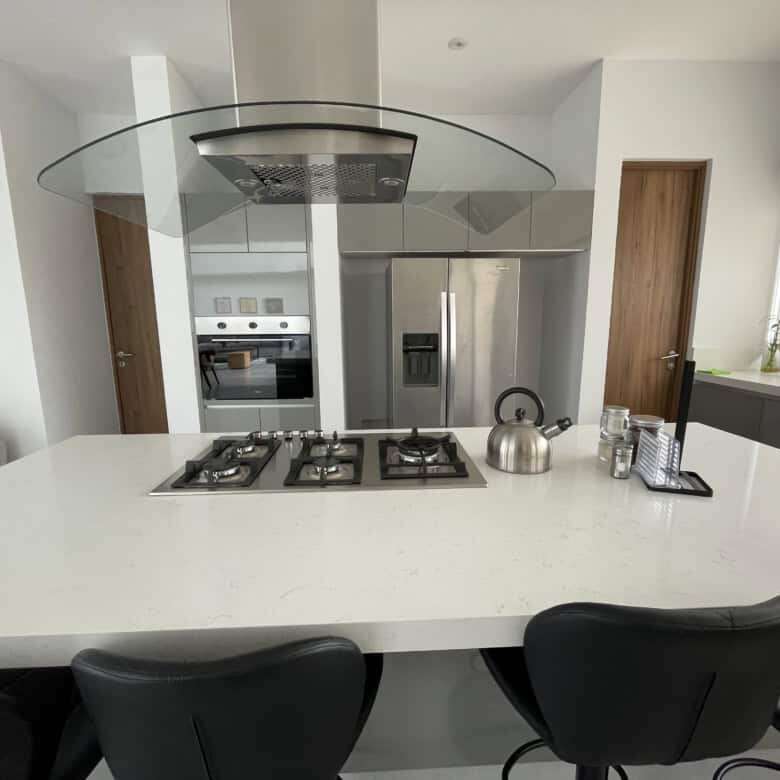 Modern kitchen with stainless steel appliances and a central island.