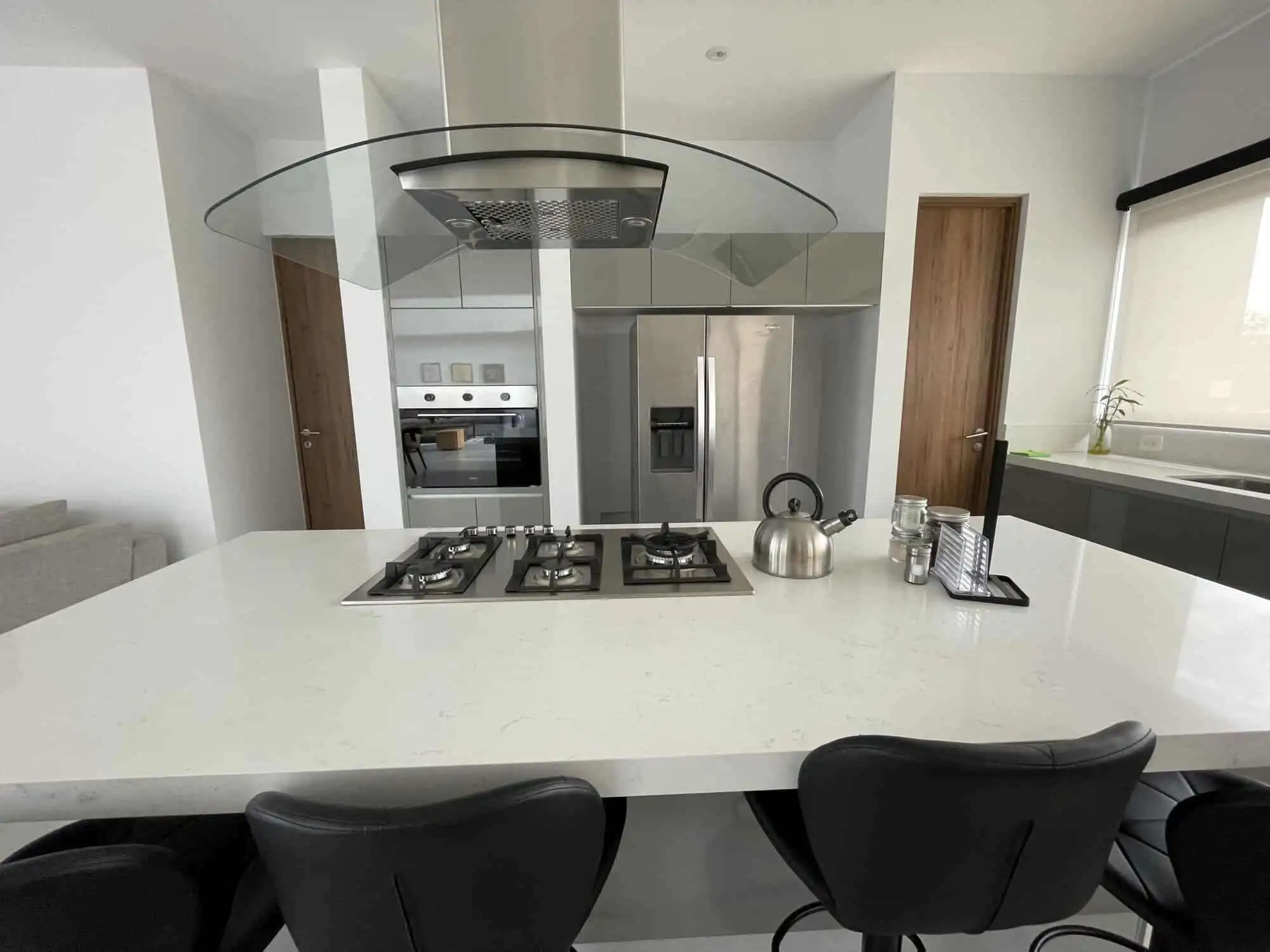 Modern kitchen with stainless steel appliances and a central island.