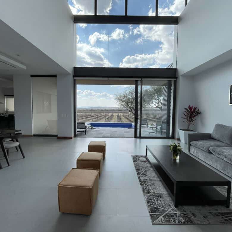 Modern living room with large glass windows and scenic views in San Miguel de Allende.