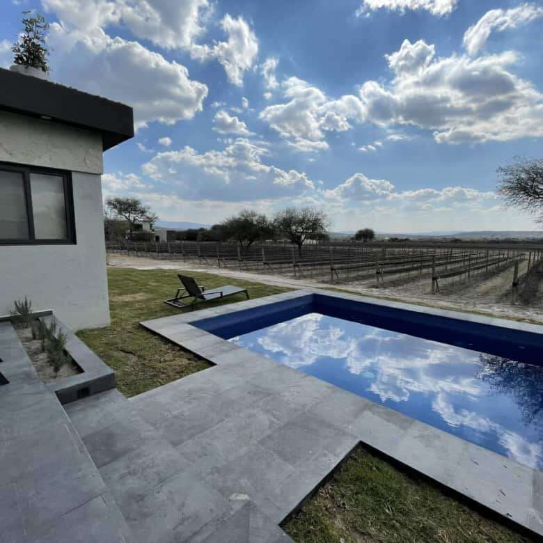 Pool with scenic vineyard views in a luxury estate in San Miguel de Allende, Mexico.
