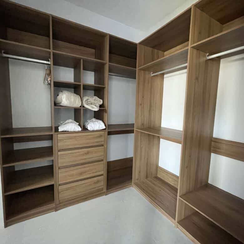Closet with wooden shelves and hanging space in a luxury vineyard estate.