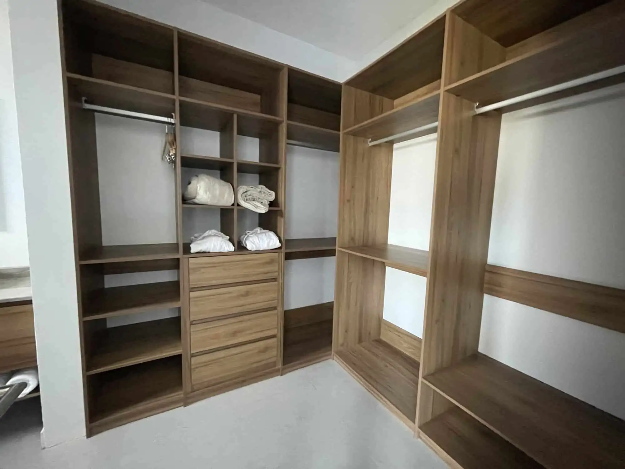 Closet with wooden shelves and hanging space in a luxury vineyard estate.