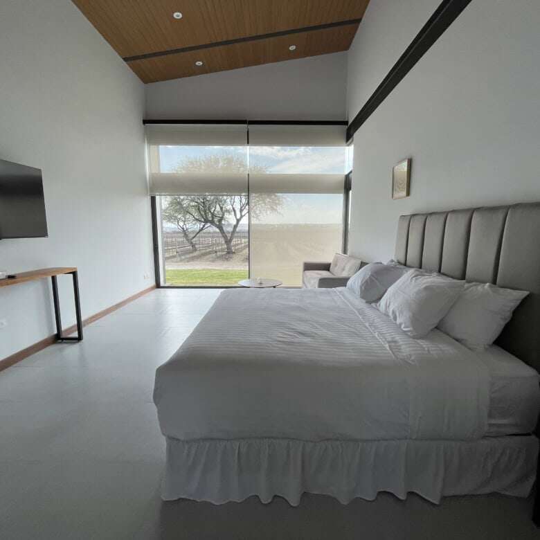 Modern bedroom with large window and scenic views in San Miguel de Allende.
