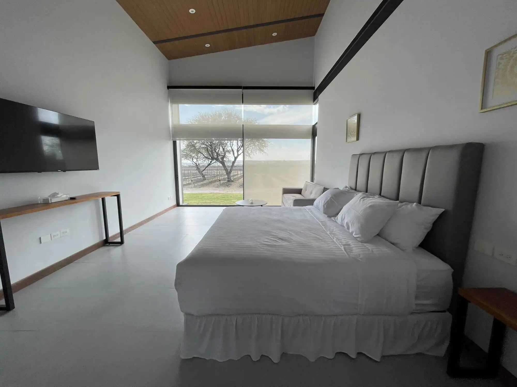 Modern bedroom with large window and scenic views in San Miguel de Allende.
