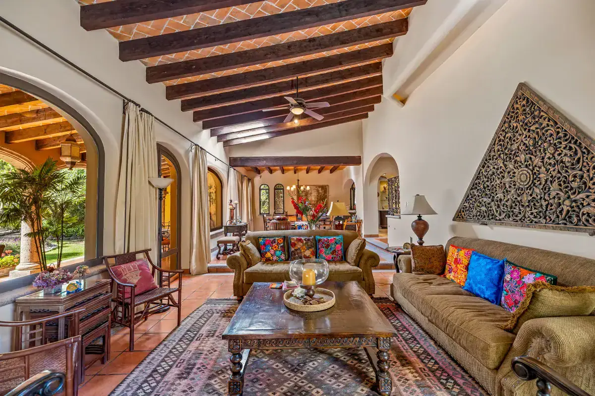 Lakefront Rancho Los Labradores Home Beautiful living room with high wooden beams and large windows overlooking the lake.