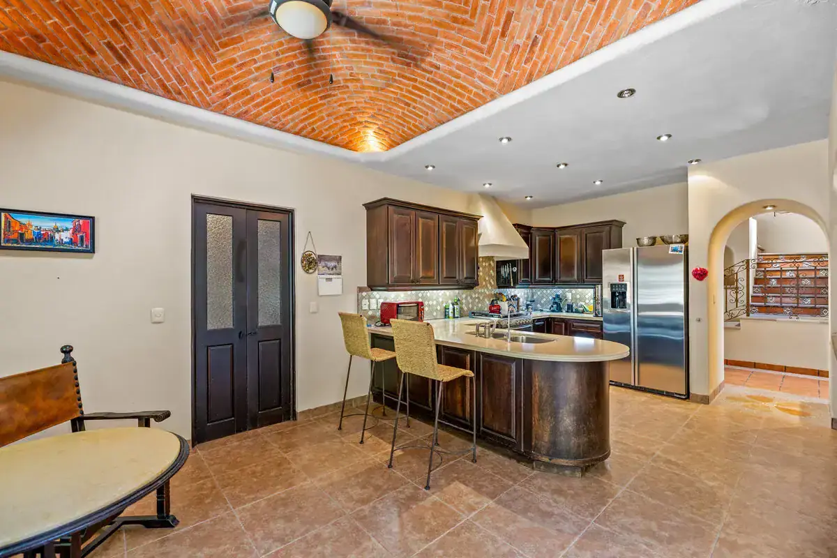 Modern Kitchen in Rancho Los Labradores Kitchen with dark wood cabinets and stainless steel appliances in Rancho Los Labradores, San Miguel.
