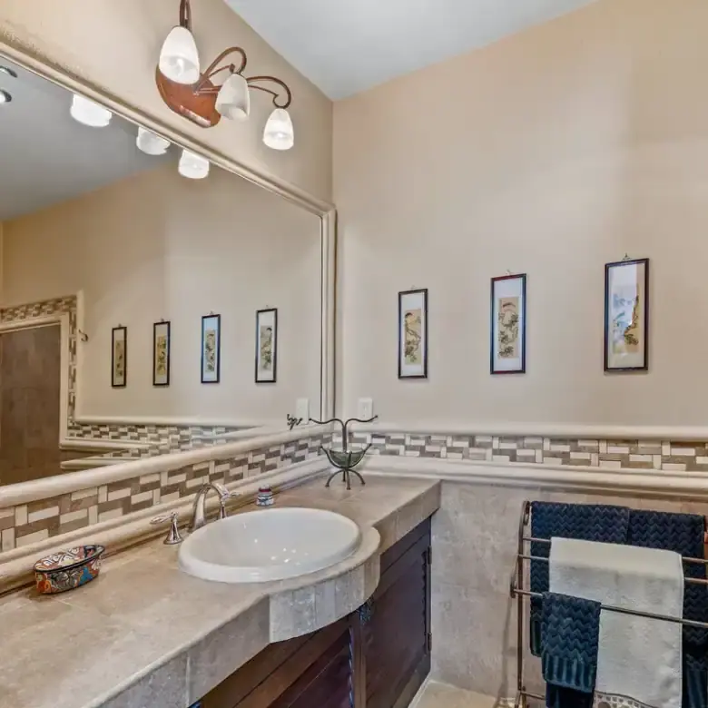 Luxurious bathroom featuring modern fixtures, decorative art, and elegant design in a lakeside prope.