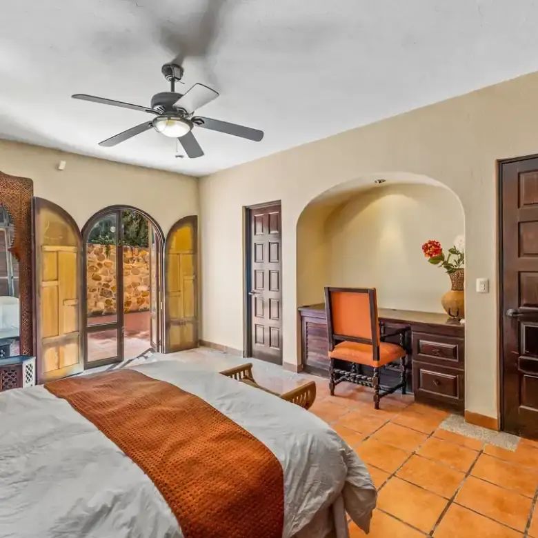 Beautiful bedroom with lake views, traditional decor, and wooden accents in Rancho Los Labradores, S.