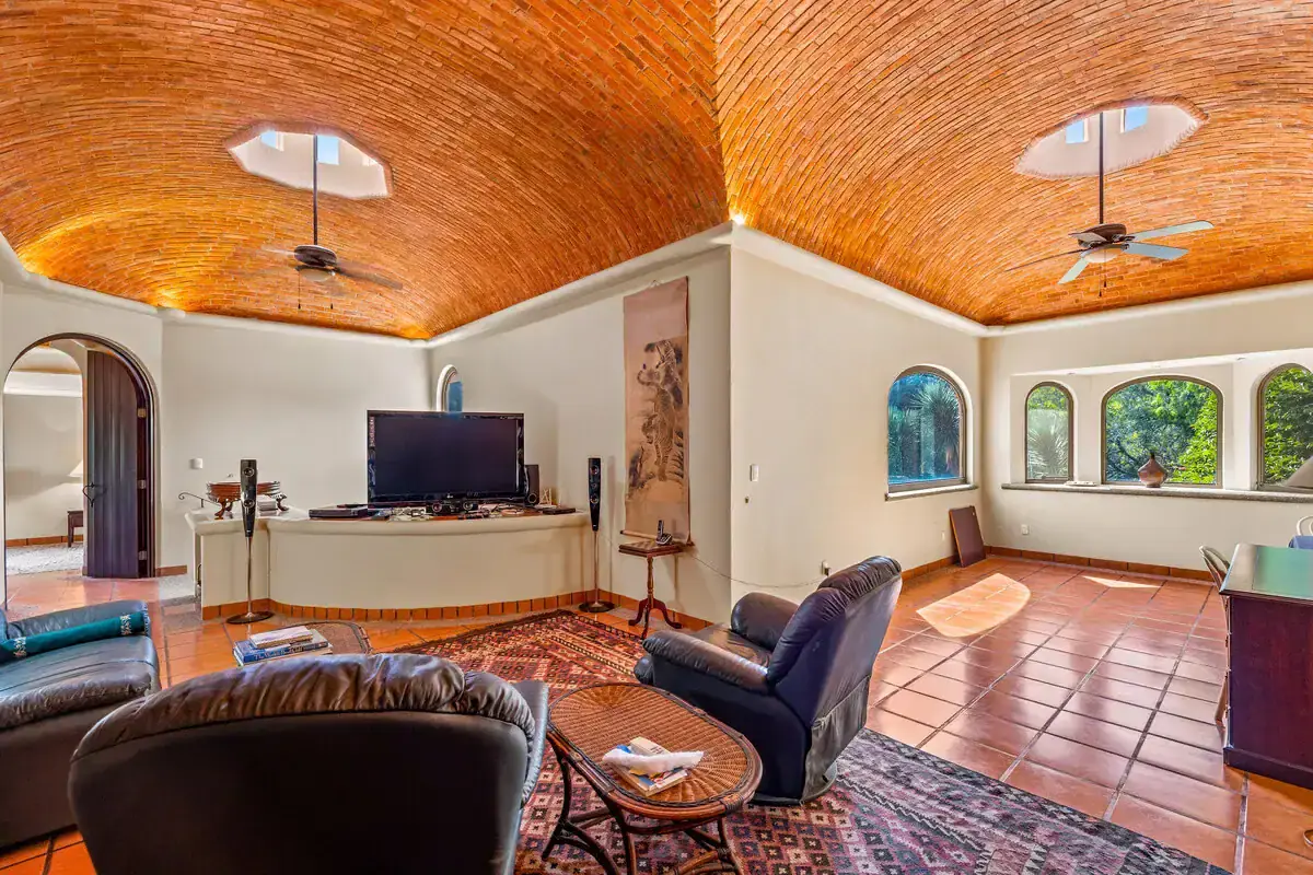Elegant Rancho Los Labradores Living Room with Brick Ceiling Spacious living area featuring a stunning brick vaulted ceiling and large arched windows overlooking.