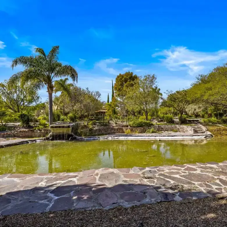 Beautiful lakefront home with lush greenery and scenic views in Rancho Los Labradores.