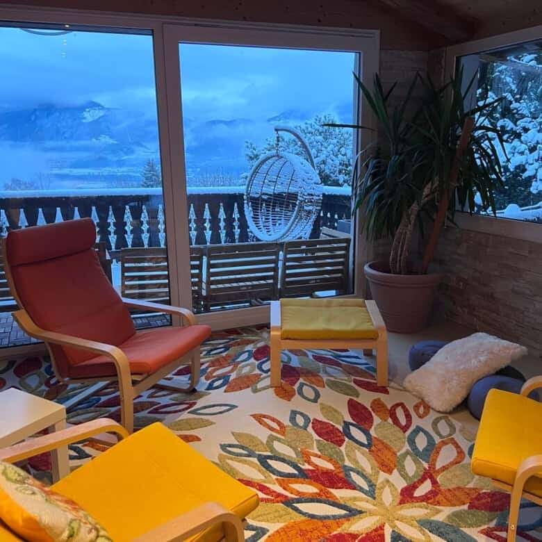Charming Swiss chalet interior with panoramic mountain views, perfect for holiday or rental investme.