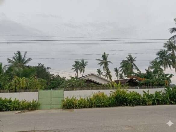 House with tropical garden and palm trees in Siargao Island, Philippines.