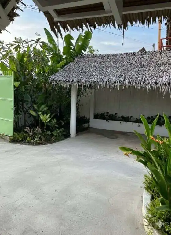 Beautiful 3-bedroom house for sale in Siargao Island with tropical garden surroundings.