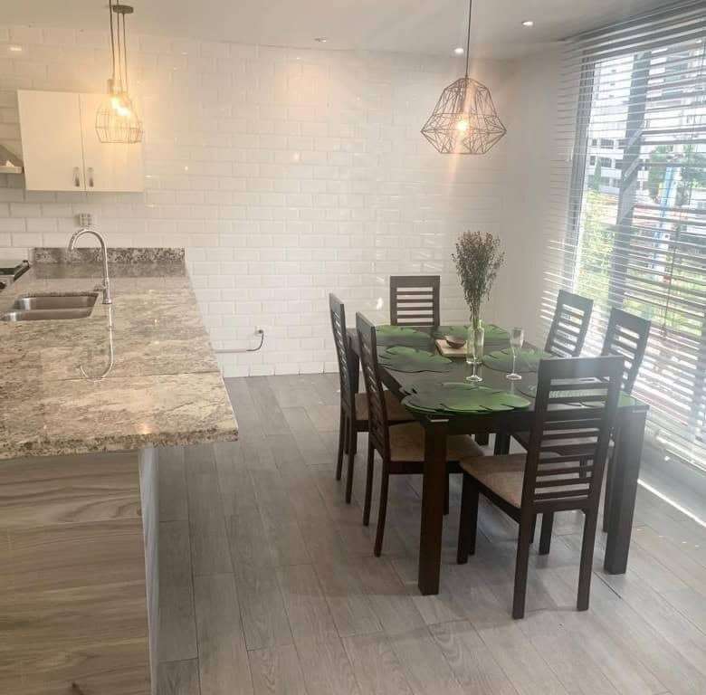 Modern kitchen and dining space with natural light and contemporary decor in Panama City.