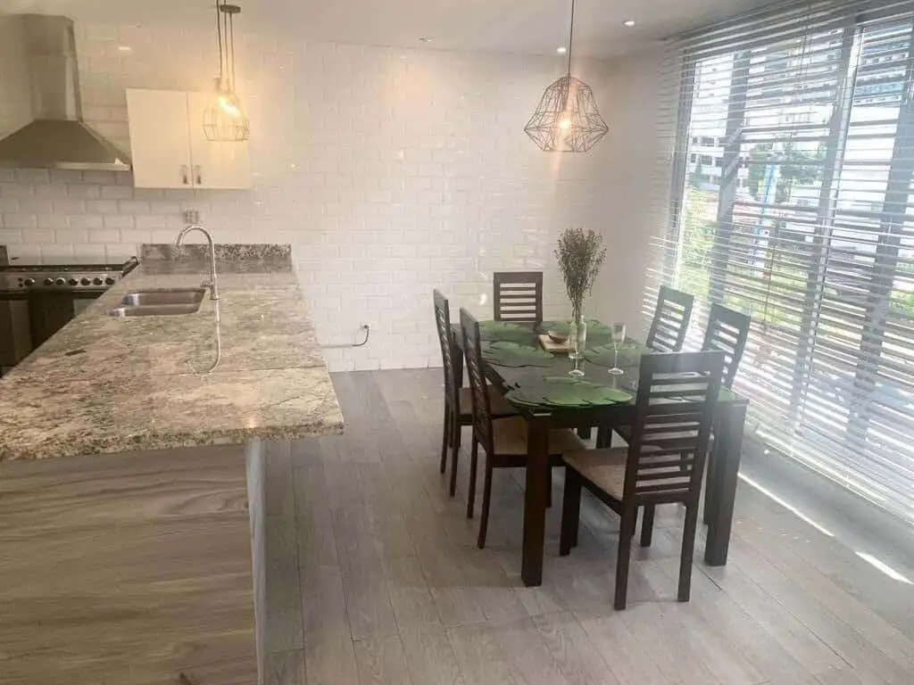 Modern kitchen and dining space with natural light and contemporary decor in Panama City.