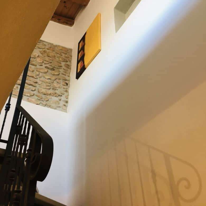 Beautiful interior staircase in a charming Sardinian home.