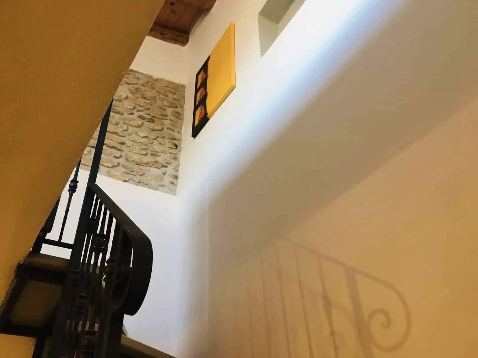 Beautiful interior staircase in a charming Sardinian home.