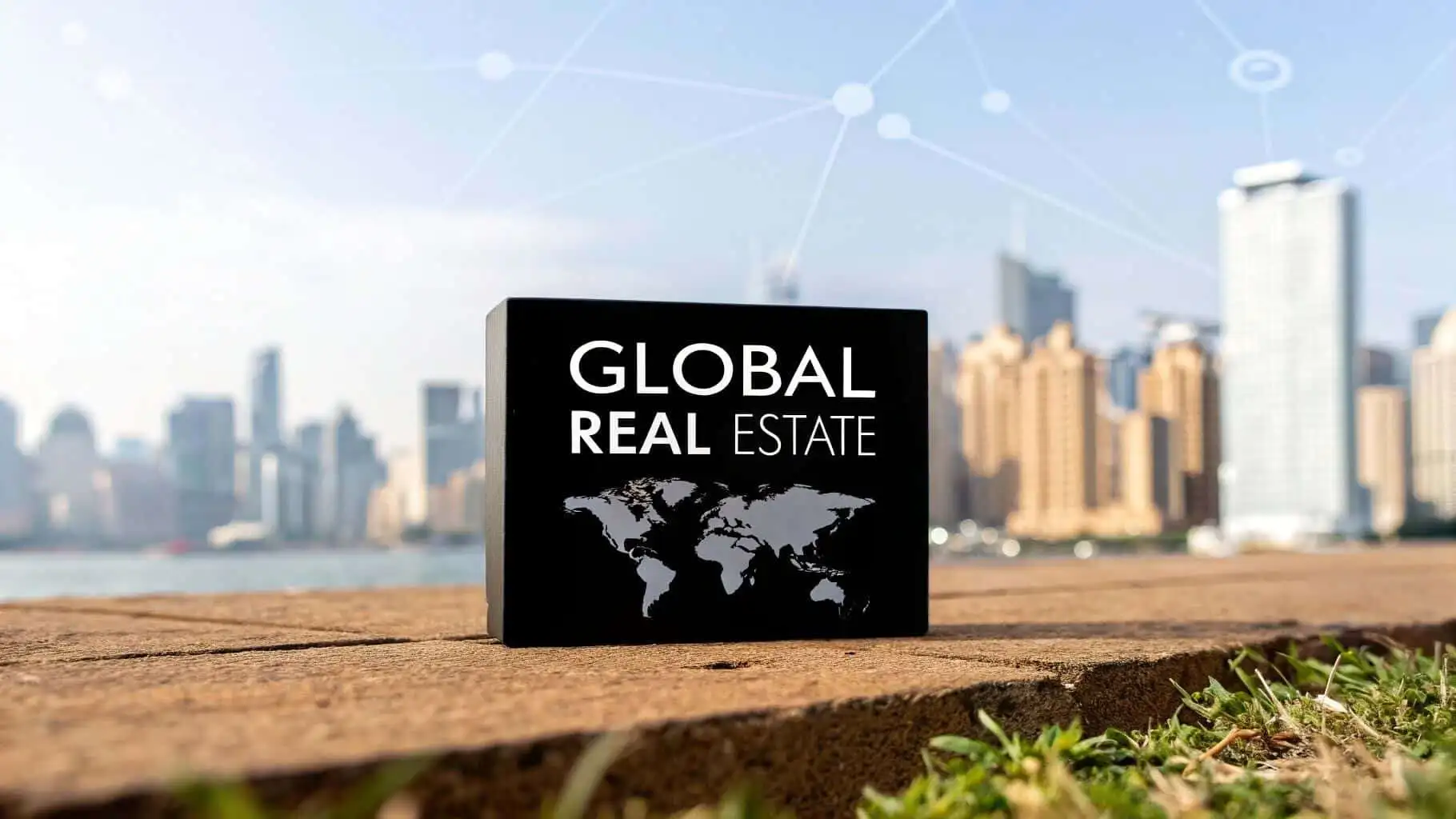 International property for sale sign with world map and city skyline background.