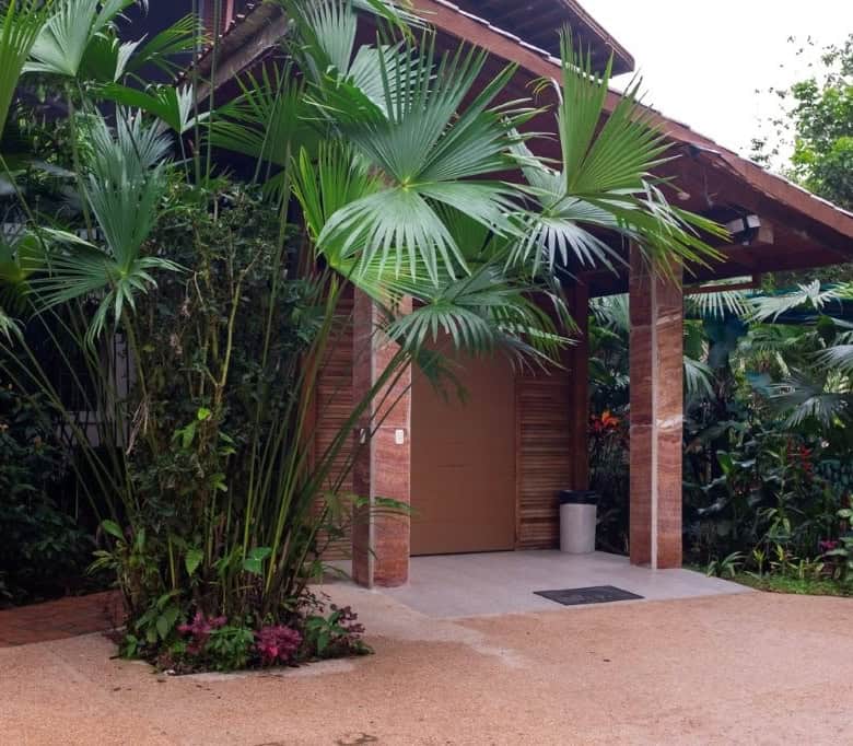 Entrance to a riverside retreat surrounded by lush tropical plants in Ecuador.