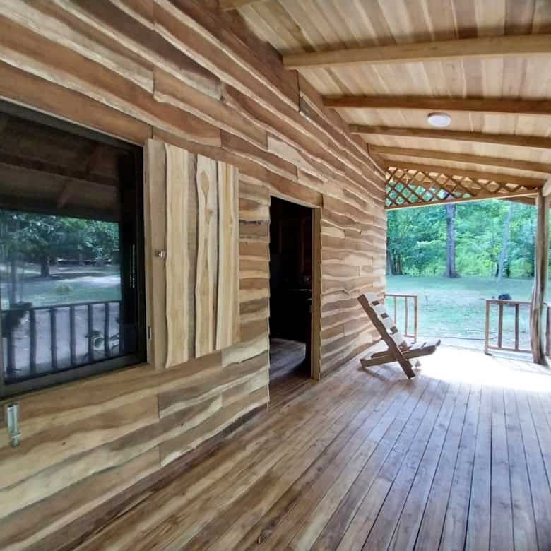 Modern wooden home in Vainilla, Costa Rica with spacious porch and lush surroundings.