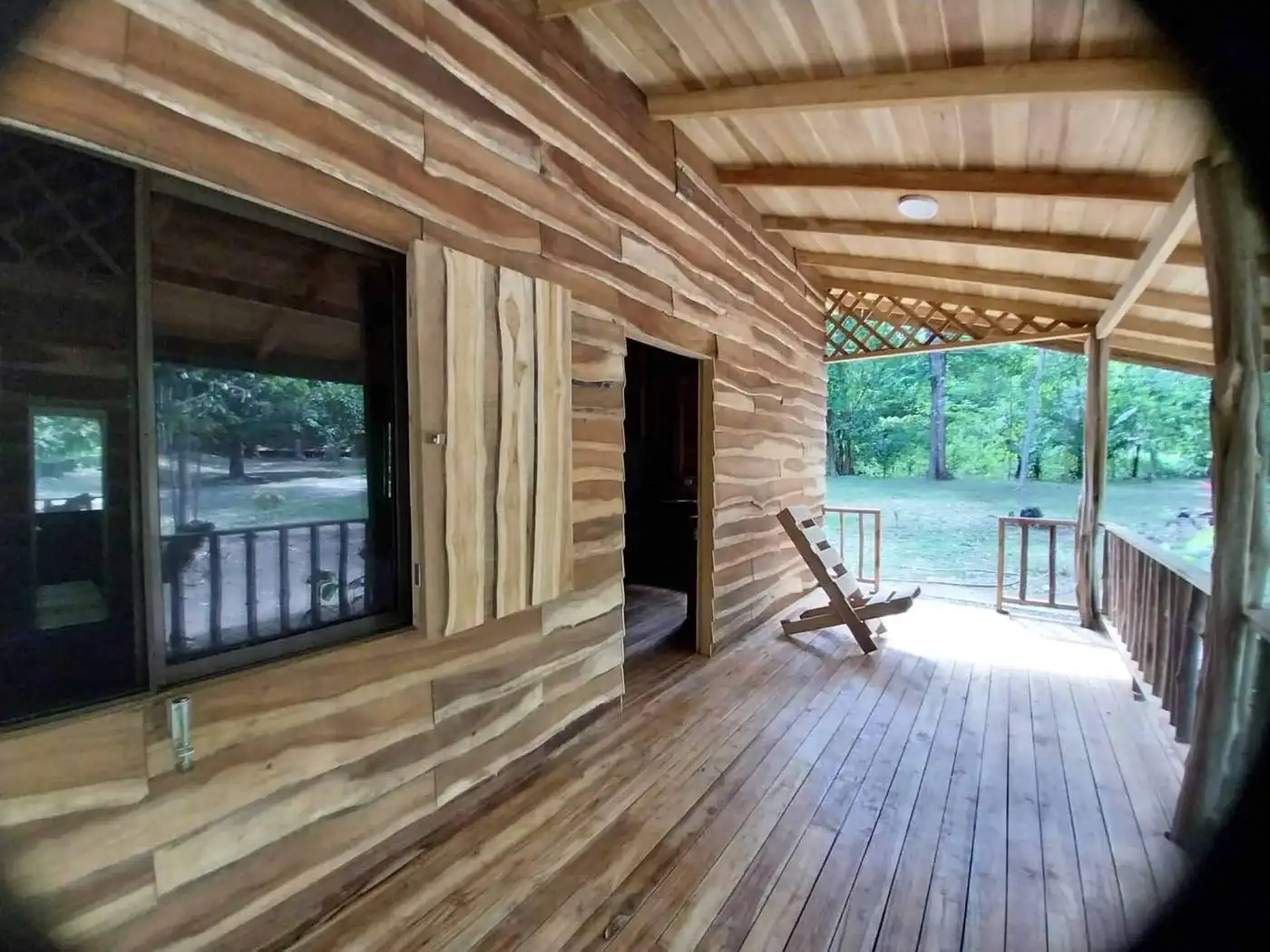 Modern wooden home in Vainilla, Costa Rica with spacious porch and lush surroundings.