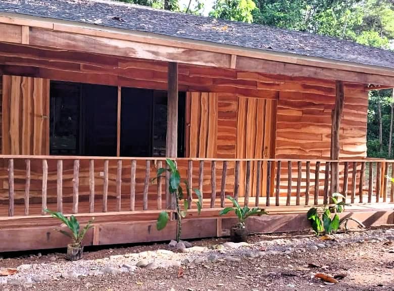 Beautiful wooden house with porch in lush green surroundings, Vainilla Costa Rica.