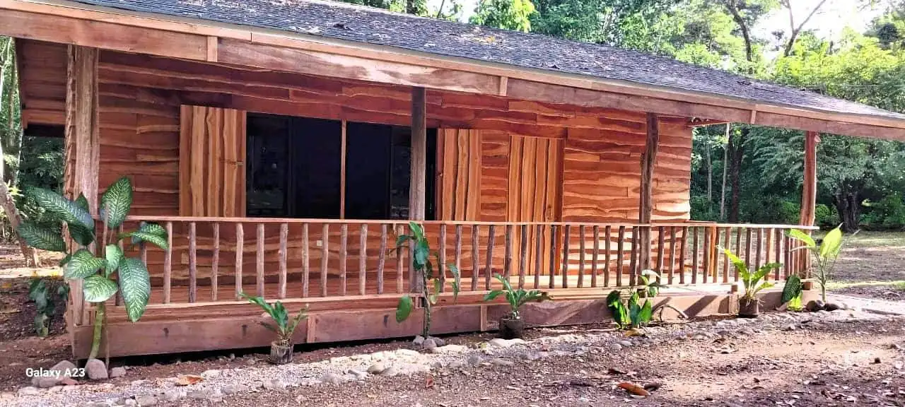 Beautiful wooden house with porch in lush green surroundings, Vainilla Costa Rica.