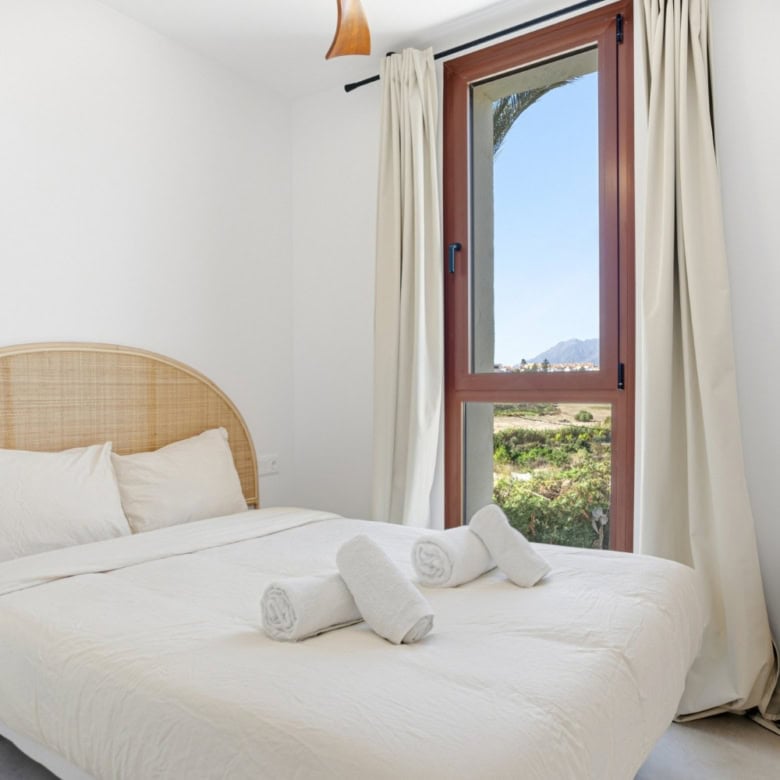 Bright bedroom featuring a large window with scenic views in Cancelada, Estepona. Perfect for relaxi.